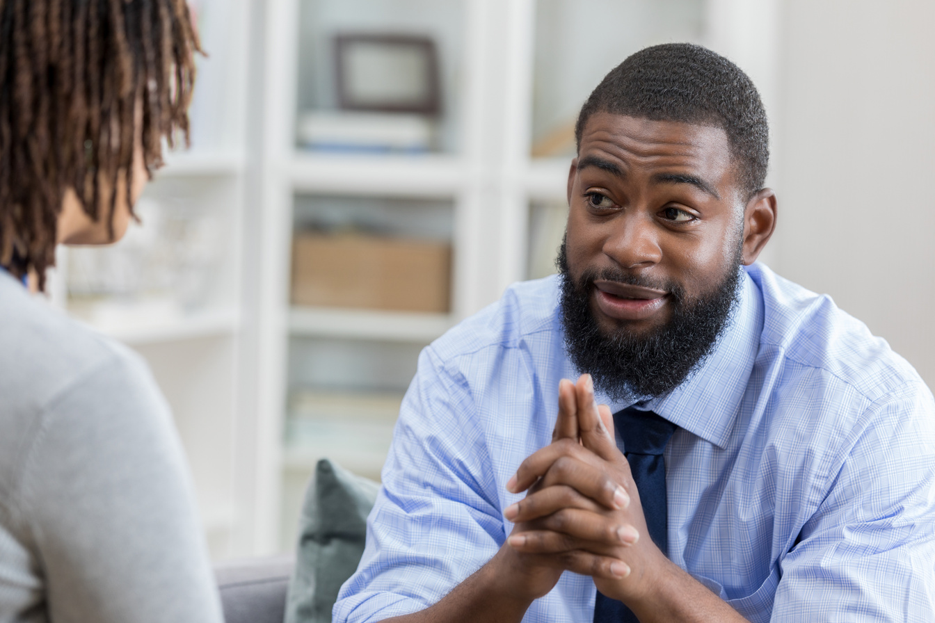Man discusses something with counselor